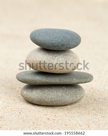 stone pyramid on sea sand