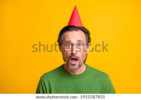 Photo of mad disappointed man hold red present open mouth wear glasses green pullover isolated yellow color background