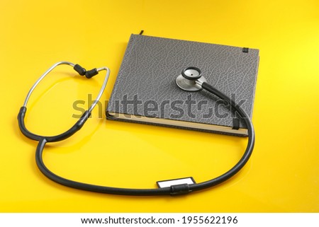 Black stethoscope lying on the diary, medicine.