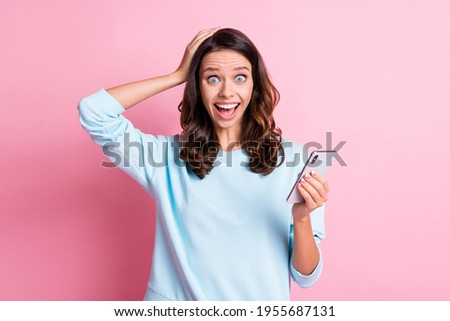 Photo of young amazed woman shocked surprised news like comment use cellphone isolated over pastel color background