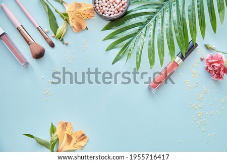 Summer female background with flowers, tropical leaves and cosmetic products background. Bright copy space, festive postcard. Creative concept. 
