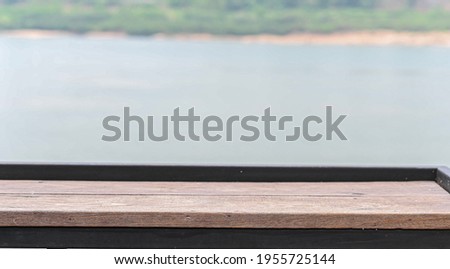 The wooden floor is outside by the river.
