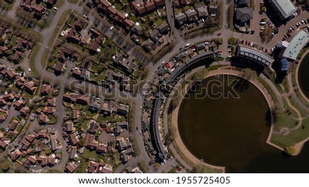 Aerial photo of the village of Caldecotte in Milton Keynes UK showing a typical British housing estate on a sunny summers day taken with a drone from above Royalty-Free Stock Photo #1955725405