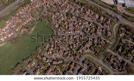 Aerial photo of the village of Caldecotte in Milton Keynes UK showing a typical British housing estate on a sunny summers day taken with a drone from above