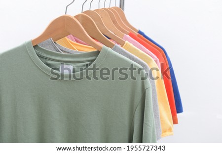 Row of colorful t-shirts with sweatshirt, long sleeved cotton T-Shirt hanging on hangers