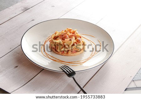 Thin Apple Pie with caramel sauce on white background
