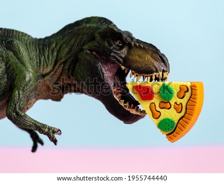Close up dinosaur with pizza in  mouth. Fast food concept.