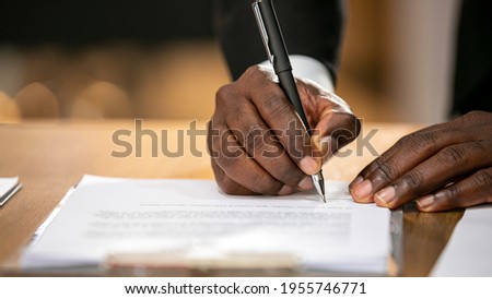 Portrait of hand signing a contract after completed and agreed with a mutaul agreement