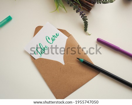 Personalized note with inscription Take Care in a natural color envelope, stay at home, health care concept