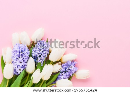 Spring flowers bouquet on a pink background. Mothers Day, Valentines Day, birthday celebration concept. Top view, copy space for text