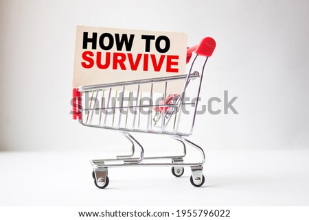 a business card with text HOW TO SURVIVE in a shopping cart. business and finance