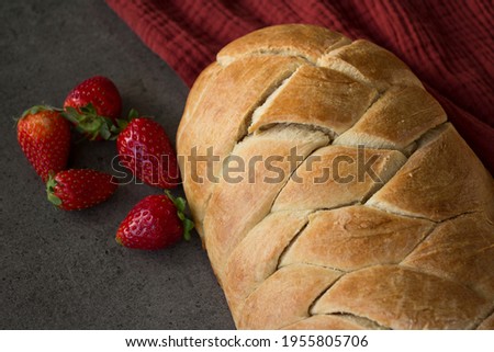 Israeli traditional Challah bread on a table. Appetizing homemade bread top view photo. Gray background.