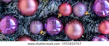 banner with Purple and violet Christmas balls. Christmas background. New Year or Xmas concept. Top view. Close up