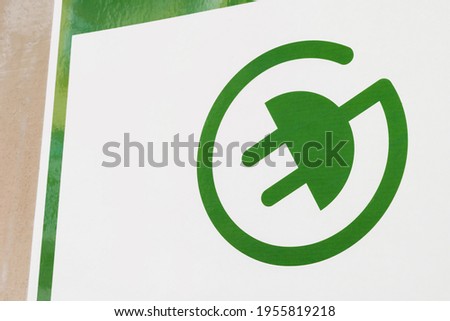 green Electric Vehicle Recharge Point Sign. A green sign of a power supply for electric cars
