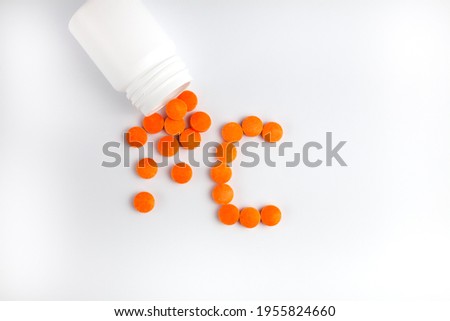 Tablets vitamin C on white background. Taking vitamins and supplements. Health and medical concept. Close-up.