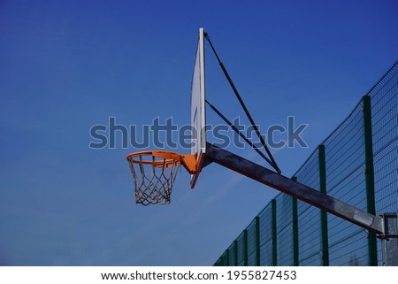 A basketball hoop in a park on a sunny  day - selective focus