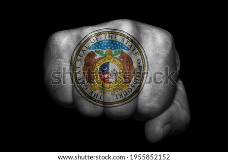 US country Missouri Seal Flag painted on strong fist on black background Royalty-Free Stock Photo #1955852152