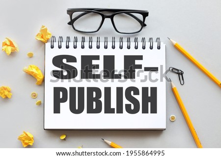 self publishing. text on white paper on gray background