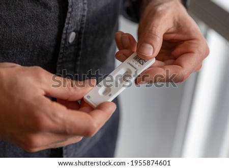 Man taking a rapid antigen test (lateral flow) for covid-19 Royalty-Free Stock Photo #1955874601