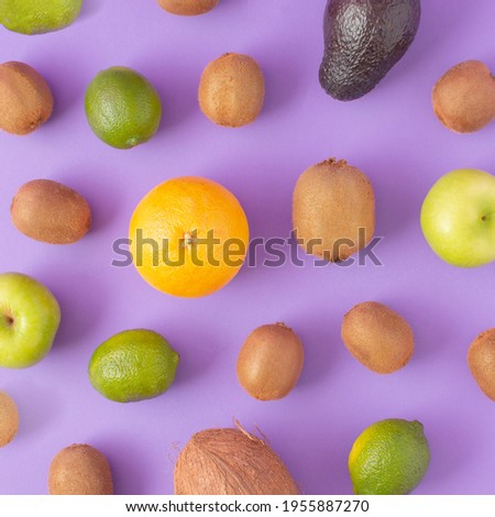 Trendy pattern made of colorfull tropical fruit on a bright violet background. Minimal concept.