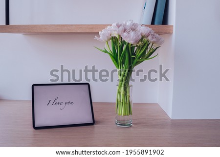 sweet photo of interior with frame I love you writing on it and vase with flower near the frame