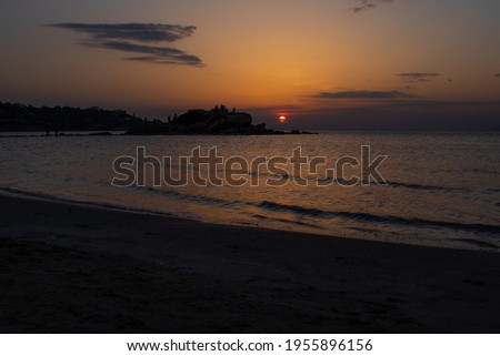 Kavouri beach with the sunset at background
