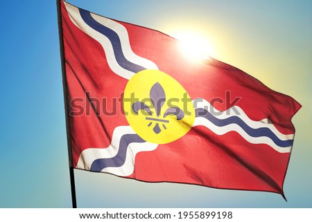 St. Louis of Missouri of United States flag waving on the wind in front of sun