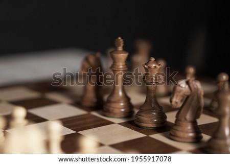 Chess, queen, Chess pieces are located on a wooden board. close-up side view queen, think