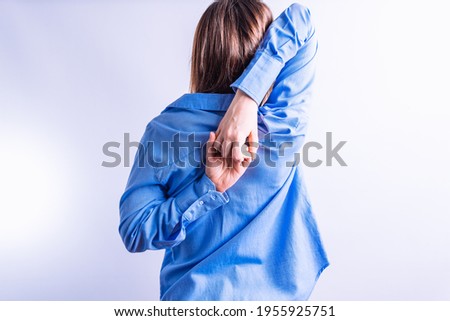 portrait beautiful young woman from behind stretching holding hands behind her back. concept stretch in the office Royalty-Free Stock Photo #1955925751