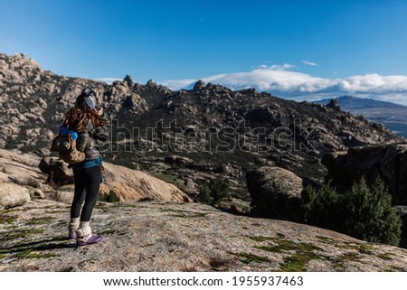 young woman taking photos in the nature