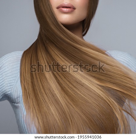 Beautiful blond girl with a perfectly smooth hair, and classic make-up. Beauty face and hair. Royalty-Free Stock Photo #1955941036
