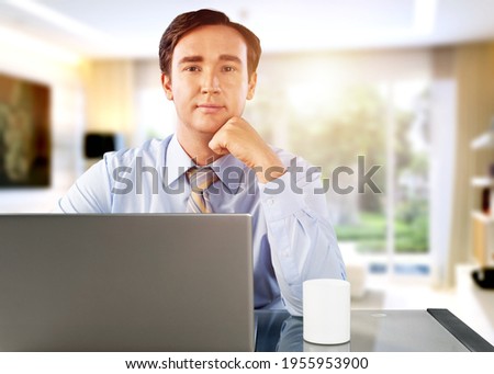 Thoughtful young man working online using laptop app