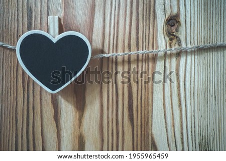 Wooden heart-shaped  nameplate on a rope, backdrop
