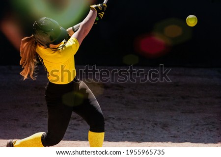 A Female Baseball Player Is Swinging For The Fences
