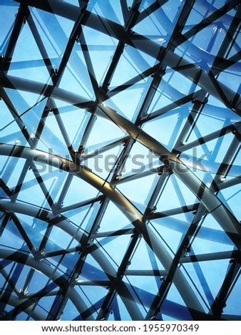 Double exposure of glass ceiling with metal framework. Close-up photo of round modular glazing structure for modern architecture, interior or technology. Hi-tech background with polygonal pattern.