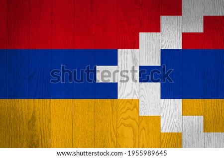 The flag of the Republic of Artsakh on a grunge wooden background.