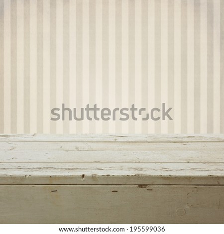 Background with empty wooden table over retro striped wallpaper Royalty-Free Stock Photo #195599036