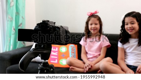 Children talking to camera building social media presence, two little girls vlogging