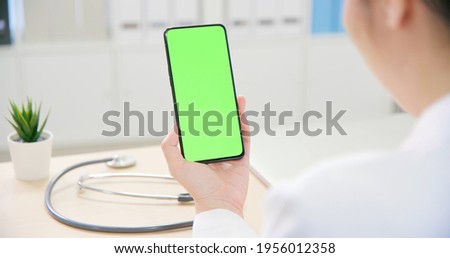 telemedicine concept - asian female doctor use green screen mobile phone to see the patient and give advice