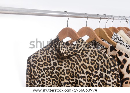 leopard pattern and brown long sleeve shirt with suit with 
knitwear .sweater warm cloth on hangers

