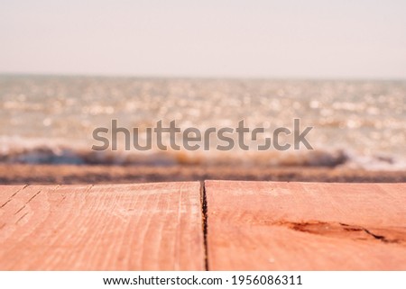 Abstract nature summer or spring ocean sea background. Small waves on golden warm water surface in motion blur with bokeh lights from sunset. Holiday, vacation and recreational background concept
