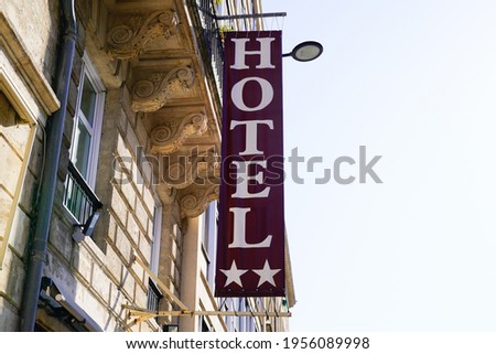 Hotel light sign text and two stars on Building in tourist city