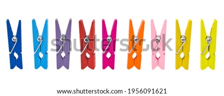 Colored wooden clothespins isolated on a white background..Detail for design. Design elements. Macro. Full focus. Background for business cards, postcards and posters. Royalty-Free Stock Photo #1956091621