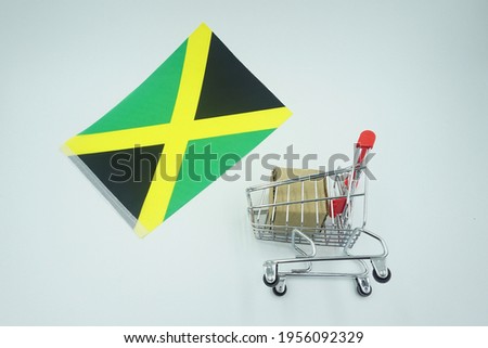Shopping trolley and flag of jamaica on white background. Online shopping concept