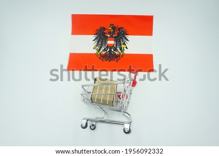 Shopping trolley and flag of Austria on white background. Online shopping concept