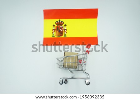 Shopping trolley and flag of spain on white background. Online shopping concept