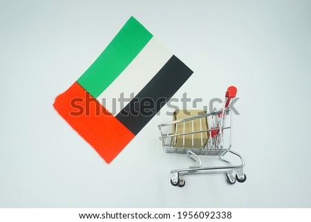 Shopping cart and United Arab Emirates flag on white background. Online shopping concept