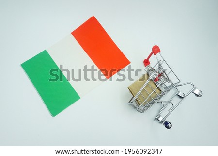 Shopping trolley and Italian flag on white background. Online shopping concept