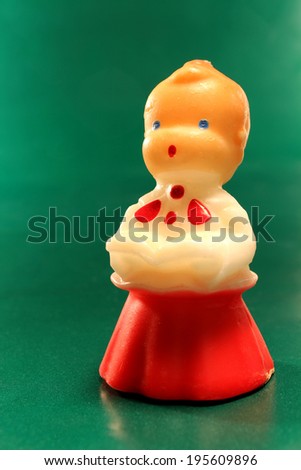 An antique christmas choir decorative candle of a boy singing.