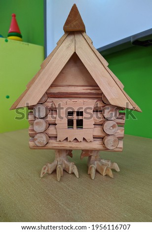 toy wooden hut on chicken legs close up photo